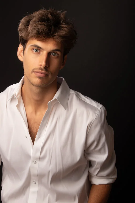 Headshot of young man in white shirt with brown hair