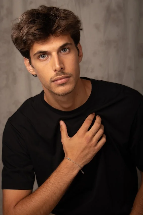 Young man in black shirt with brown hair